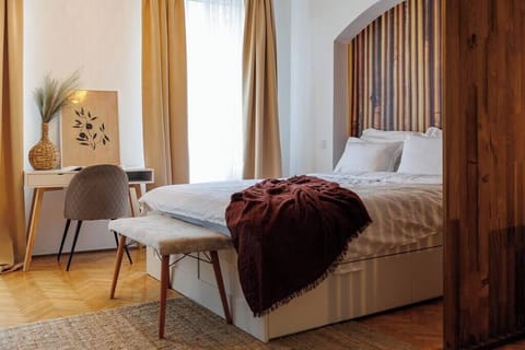 Queen size bed next to dedicated workplace