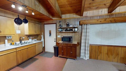 The entrance leads you right to the kitchen where you can enjoy homecooked meals from the comfort of the cabin.