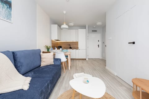 A wide-angle view of the living room, highlighting its bright and airy feel, complemented by minimalist decor.

