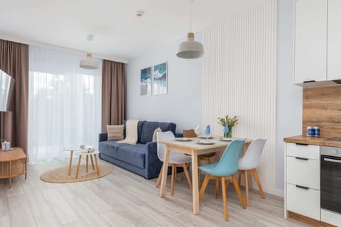 A full view of the apartment’s layout, blending modern kitchen design with comfortable living and dining areas.

