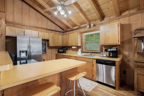 You'll love cooking in this beautifully appointed kitchen with modern stainless steel appliances and warm wood cabinetry throughout.