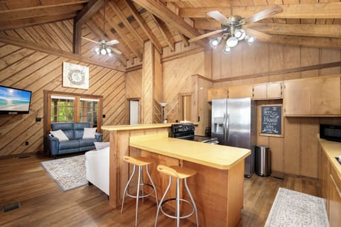Gather in your open-concept retreat with soaring wood beams, modern kitchen island, and cozy living space perfect for memorable evenings together.