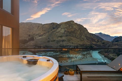 Balcony Retreat: Soak in the stunning views and unwind in your private hot tub!