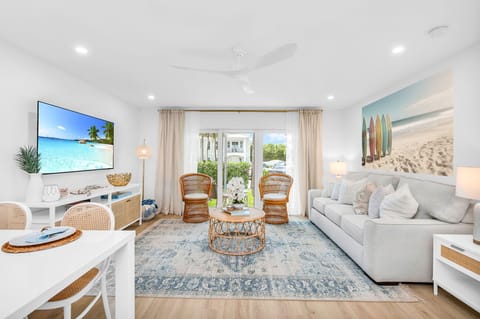 This designer living room is an open space for family and friends to share conversation, play "Florida-poly" or the Gray Malin Backgammon board, read an array of coastal and tropical books, or enjoy your favorite shows on the large 65" TV.