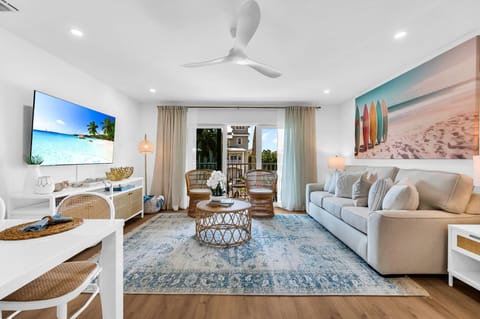 This designer living room is an open space for family and friends to share conversation, play "Florida-poly" or the Gray Malin Backgammon board, read an array of coastal and tropical books, or enjoy your favorite shows on the large 65" TV.