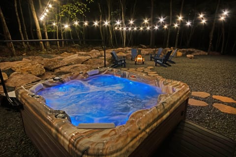 Outdoor Oasis: Relax under twinkling lights in your private hot tub by the fire pit!