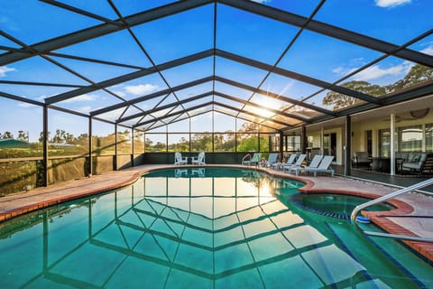 Relax under the screened-in lanai with a sparkling pool, spa, and serene views—your private Florida retreat awaits!