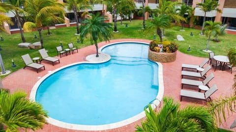 Step outside to your private oasis featuring a pristine pool, perfect for a refreshing dip or leisurely sunbathing. The sparkling water invites you to unwind and relax, surrounded by comfortable lounge chairs and a serene atmosphere.