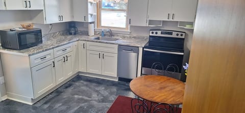 Modern, fully stocked kitchen with stainless steel appliances.