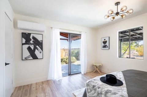 Master bedroom featuring king size bed and sliding doors to Sunrise Patio.