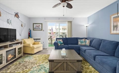 Living room w. pullout couch that overlooks the water and walks out to balcony.