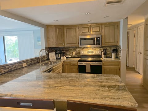 Beautiful Granite counters & custom cabinetry in this Newly renovated kitchen!