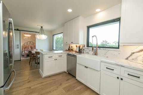 Featuring Farm sink, picture window, copper faucet, upgraded quartz countertops!