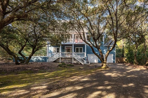 Front of house adorned with Live Oaks