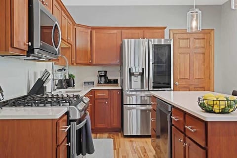 Fully stocked kitchen with island and barstool seating.