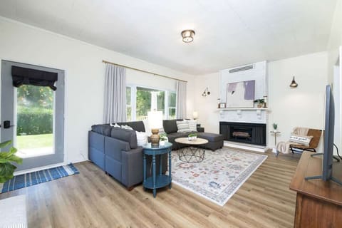 Open living room w/ comfy seating, TV & easy flow into the kitchen