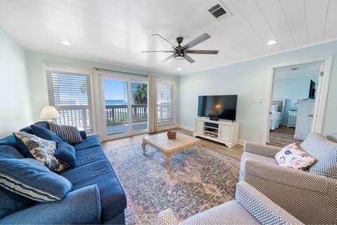 Unwind in your bright coastal living room with ocean views and comfortable seating for perfect beach house relaxation.