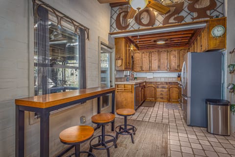 Kitchen Area with bar stools and a door that leads out to BBQ and outdoor dining