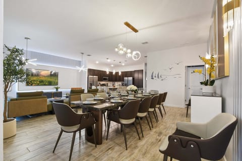 Spacious open-concept dining and living area with modern decor and elegant lighting.