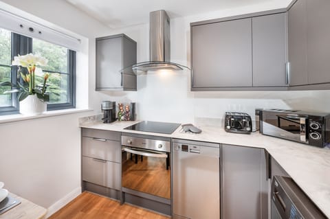 Fully equipped modern kitchen with sleek appliances, perfect for cooking and entertaining.