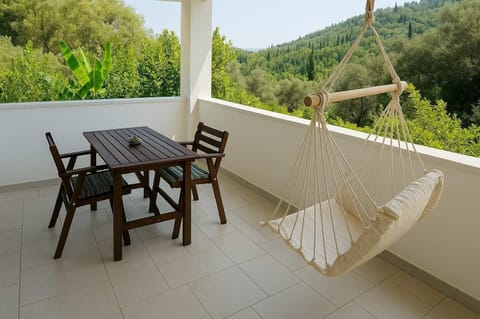Relax on the Balcony with Tranquil Mountain Views and Comfortable Hammock Chairs