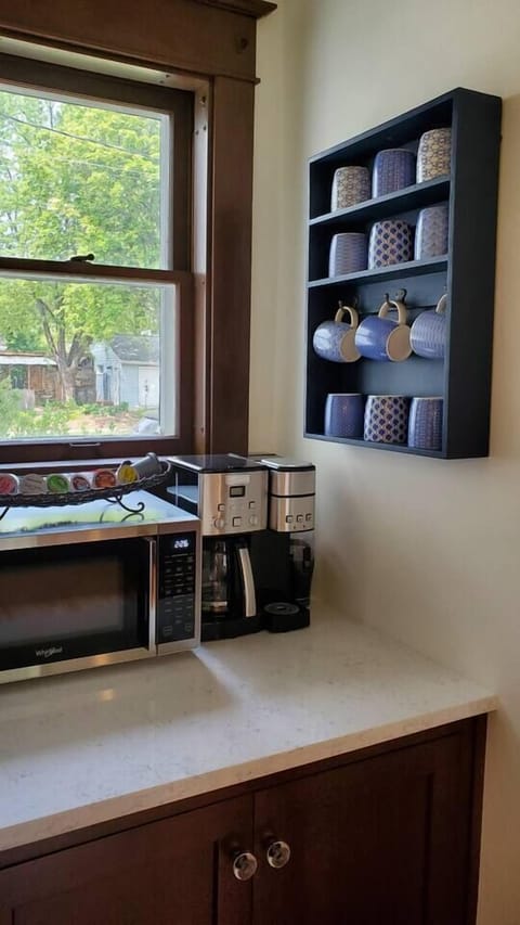 Enjoy the provided coffee, tea, and snacks in this cute nook. The cabinet is equipped with small appliances, cake pans, baking dishes, and more.