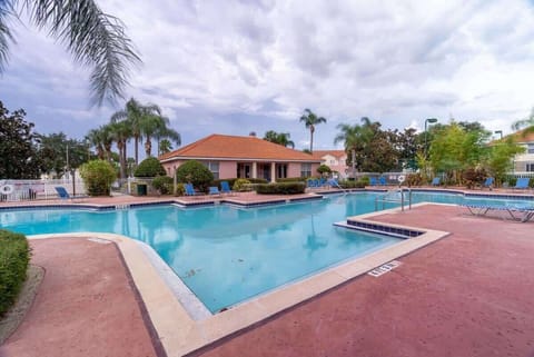 Outdoor pool area with lounge chairs and tropical landscaping for relaxing.