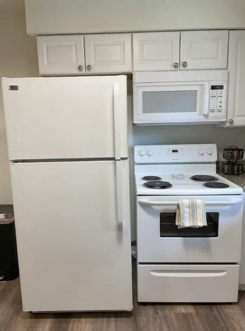 Full-sized refrigerator, over, cooktop and microwave oven.