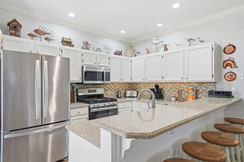 The open kitchen overlooks the dining area with plenty of seating