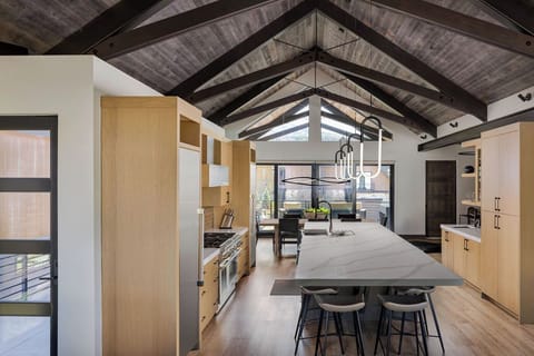 The gourmet kitchen and dining area flow together