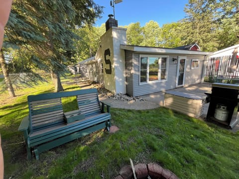 Side view, front of cottage & campfire pit.