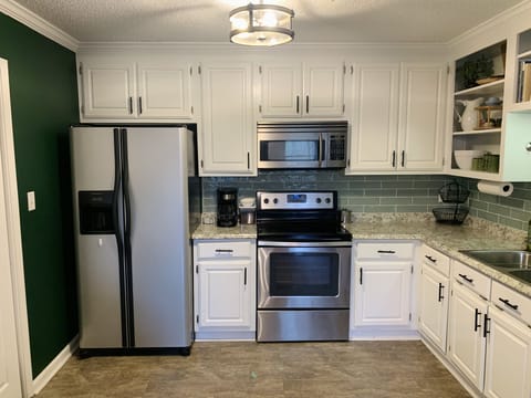 Cozy kitchen area with plenty of cooking supplies.