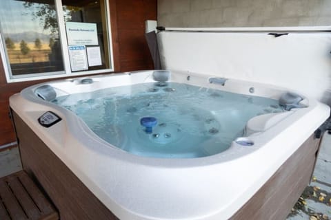 Hot Tub with golf course views jacuzzi under front porch