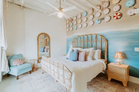 Drift off under a canopy of vintage umbrellas and dreamy blue skies in this calming king suite. (Primary bedroom)