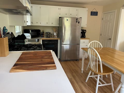 Kitchen showing oven/range, microwave, dishwasher, spices, fridge, coffeemaker