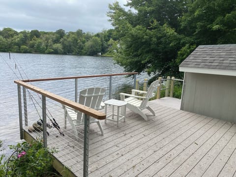 Deck w/ steps to private sandy beach, boathouse, swim dock
