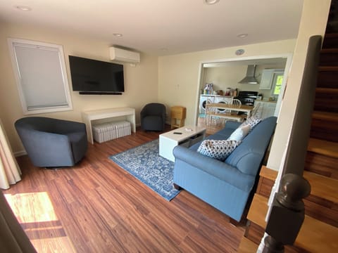 Living room with 55" QLED 4K TV, 3-channel sound bar on full-motion pivot stand