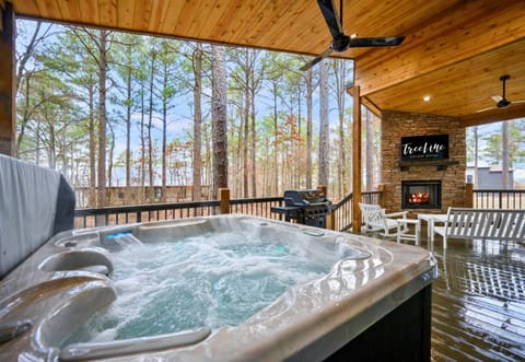 Soak in the hot tub with a beautiful forest view on the covered deck.