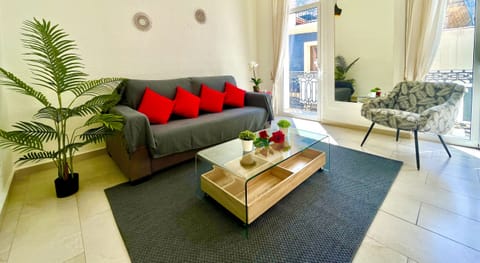 Relax in our cozy living room with a comfortable sofa bed, a balcony to enjoy the fresh air, and air conditioning for an ideal temperature all year round.
