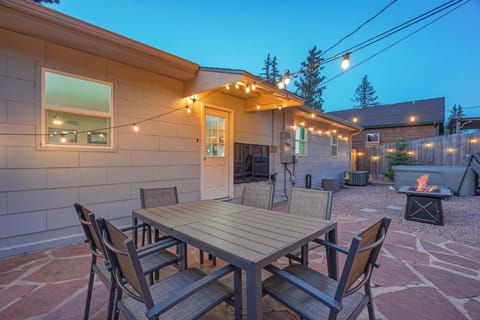 Beautiful back patio with hot tub, fire pit, and outdoor table!