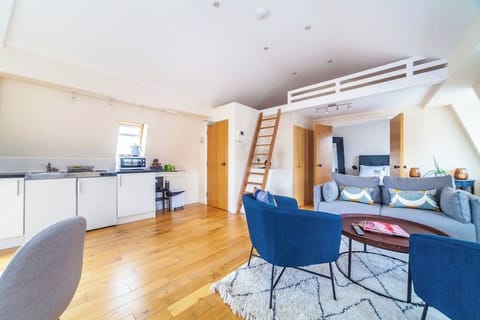 Open Plan living room with steps up to mezzanine sleeping area