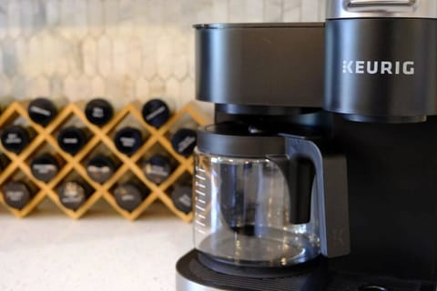 The fully-stocked kitchen has a Keurig, spice rack, blender, knife block, etc.