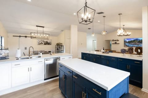 Sleek, sophisticated chef’s kitchen; island & breakfast bar of white granite.