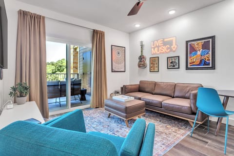 Spacious living with small desk or dining area, and tribute wall to Texas Music