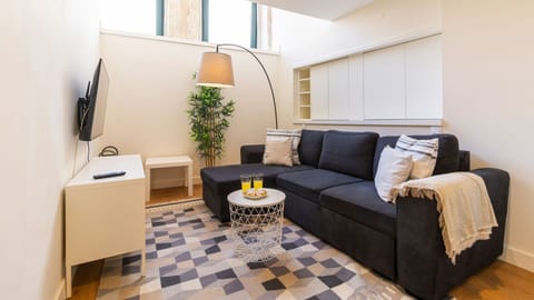 Our living room counts with an extremely comfortable couch, where you can enjoy the natural light #bright #classy