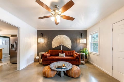 ✨Experience modern elegance and rustic charm in our curated living room. Sofa transforms to a memory foam queen bed for guests. Entertain on a 65" TV w/ Apple TV, books, games, and a waterproof speaker!  