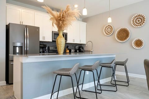 The fully equipped kitchen features modern appliances, sleek cabinetry, and all essential cookware and utensils, making it perfect for preparing meals with ease.