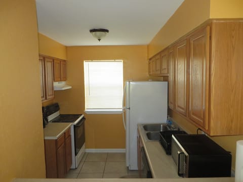 Fully stocked kitchen. Drip coffee maker, microwave, oven, fridge, dishwasher.