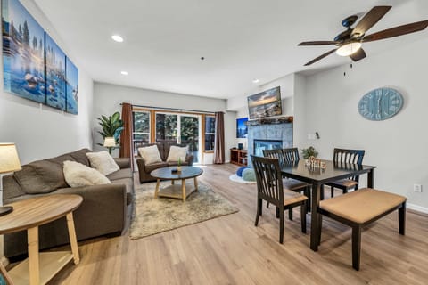 Living room: Gas fireplace, 55” Smart TV, pull-out full sofa, hardwood floors, forest views