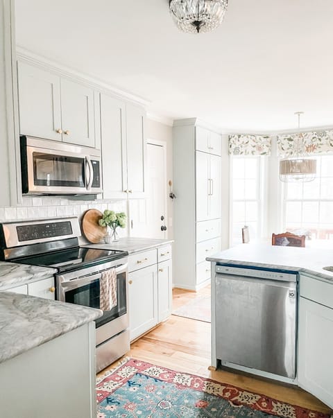 Bright and modern kitchen with stainless steel appliances, marble countertops, and natural light pouring in. Perfect for cooking and gathering!